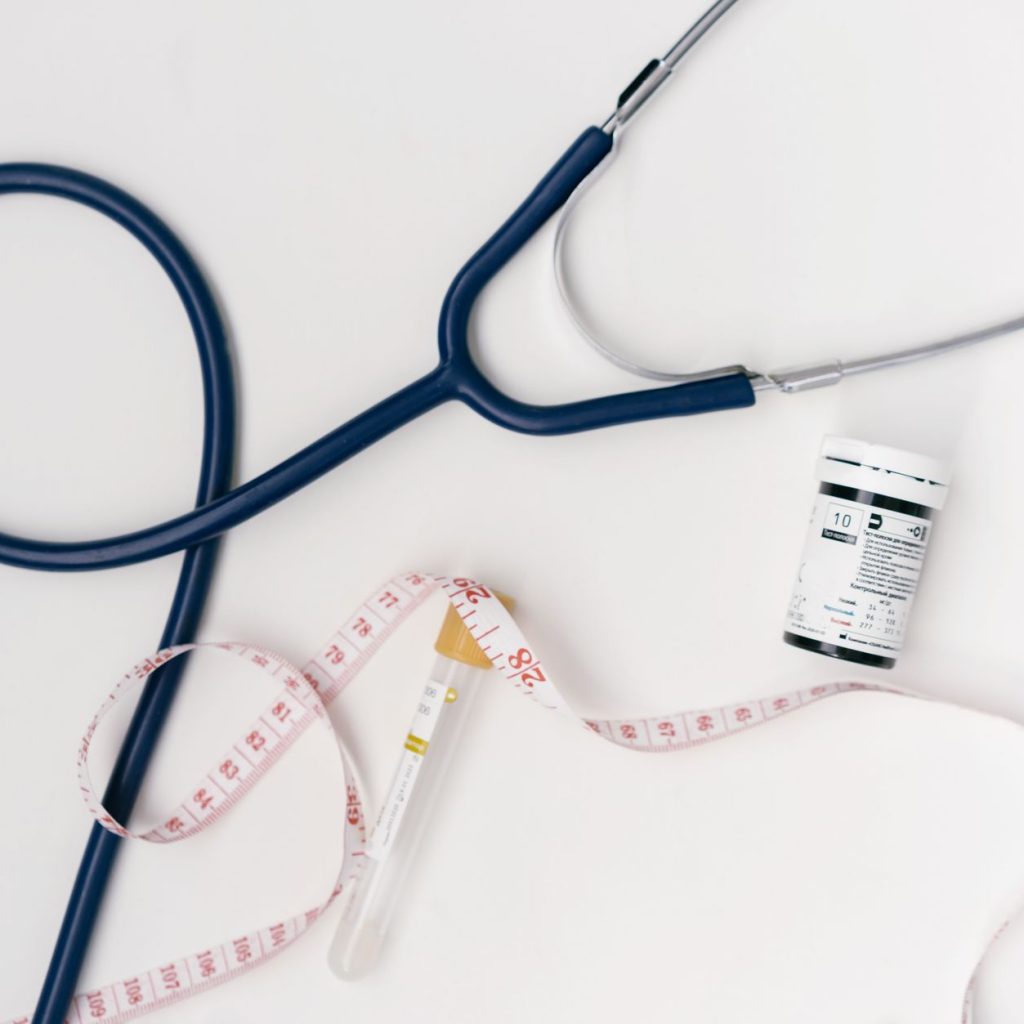 Flat lay of medical tools including stethoscope and measuring tape on a white background. — A Healthier Lifestyle for Your Do