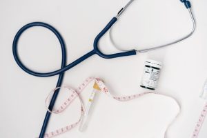 Flat lay of medical tools including stethoscope and measuring tape on a white background. — A Healthier Lifestyle for Your Do