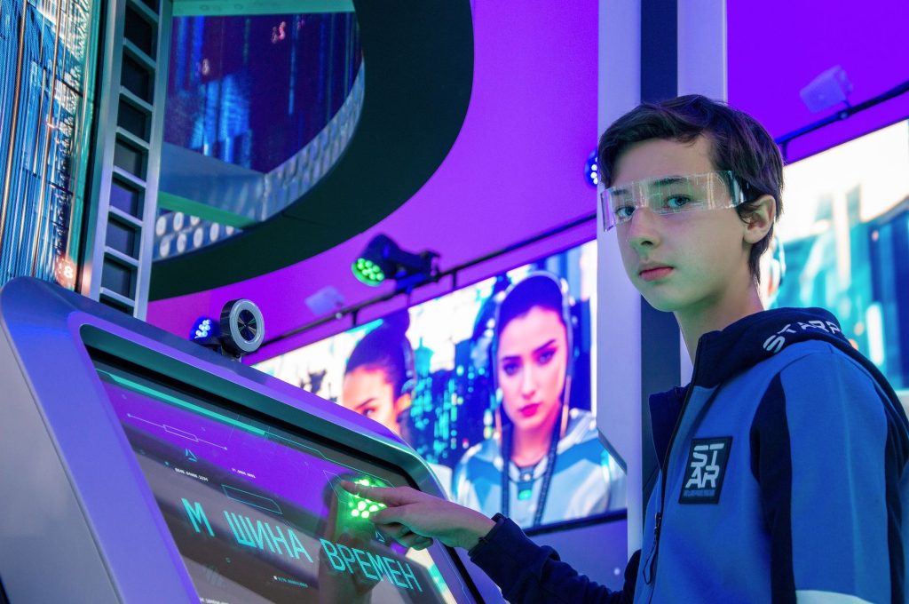 Teen boy in a digital room interacting with a futuristic touchscreen device wearing protective goggles. — AI Model Selection
