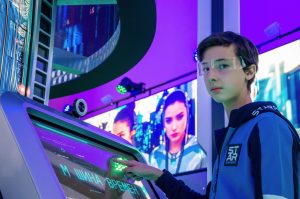 Teen boy in a digital room interacting with a futuristic touchscreen device wearing protective goggles. — AI Model Selection