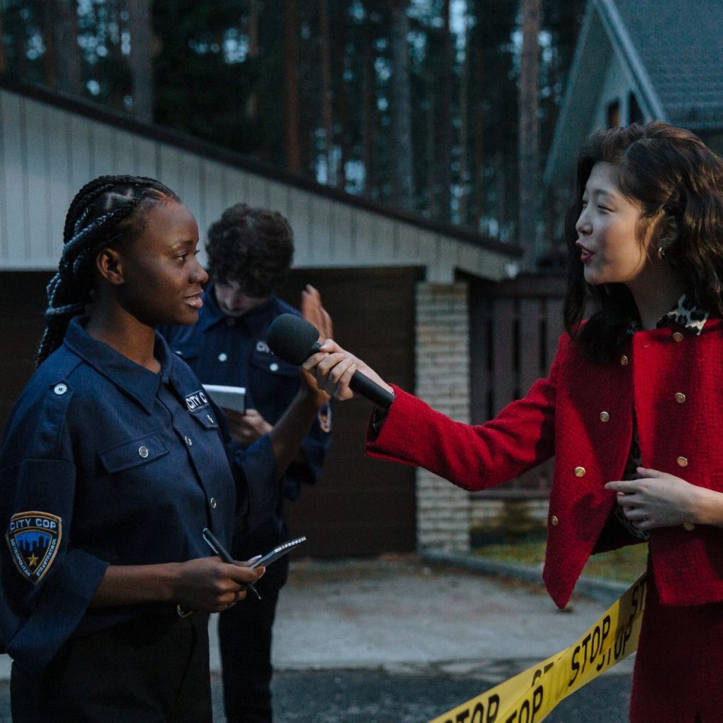 A journalist interviewing a policewoman at a crime scene during twilight. — Football Betting Maximizes Matchday Thrill With D