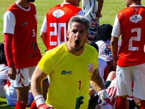 Goalkeeper in action with team during a competitive soccer match outdoors. — The Best Place for Sports Fans to Connect: La Gr