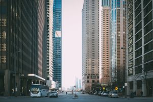 Vibrant city street scene with tall skyscrapers and city life full of cars and pedestrians. — YACSS SEO Conference 2024: The